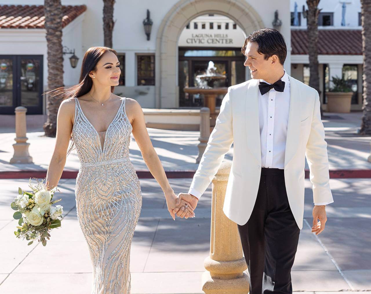 couple infront of wedding venue couple infront of wedding venue