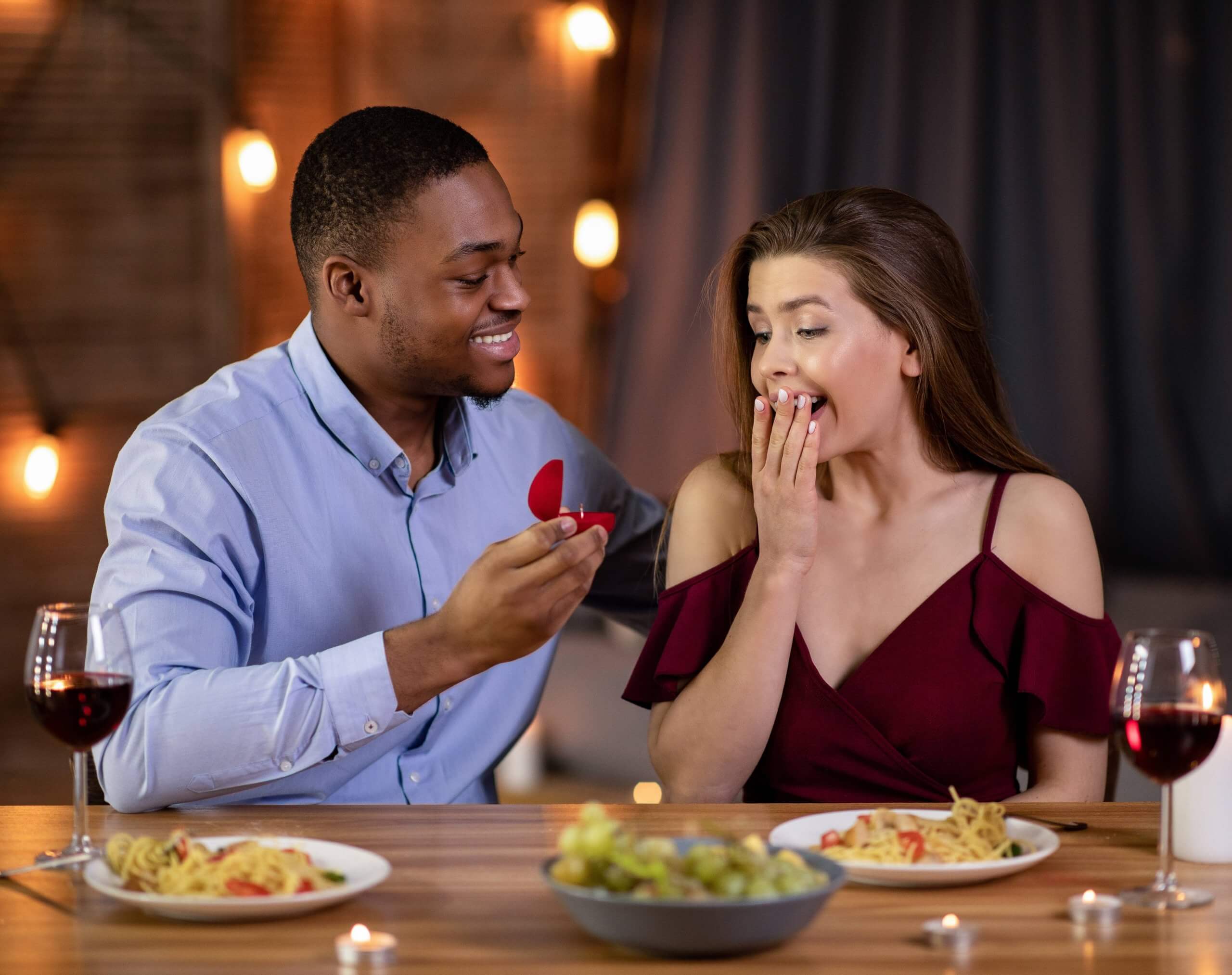 man proposing during romantic dinner date