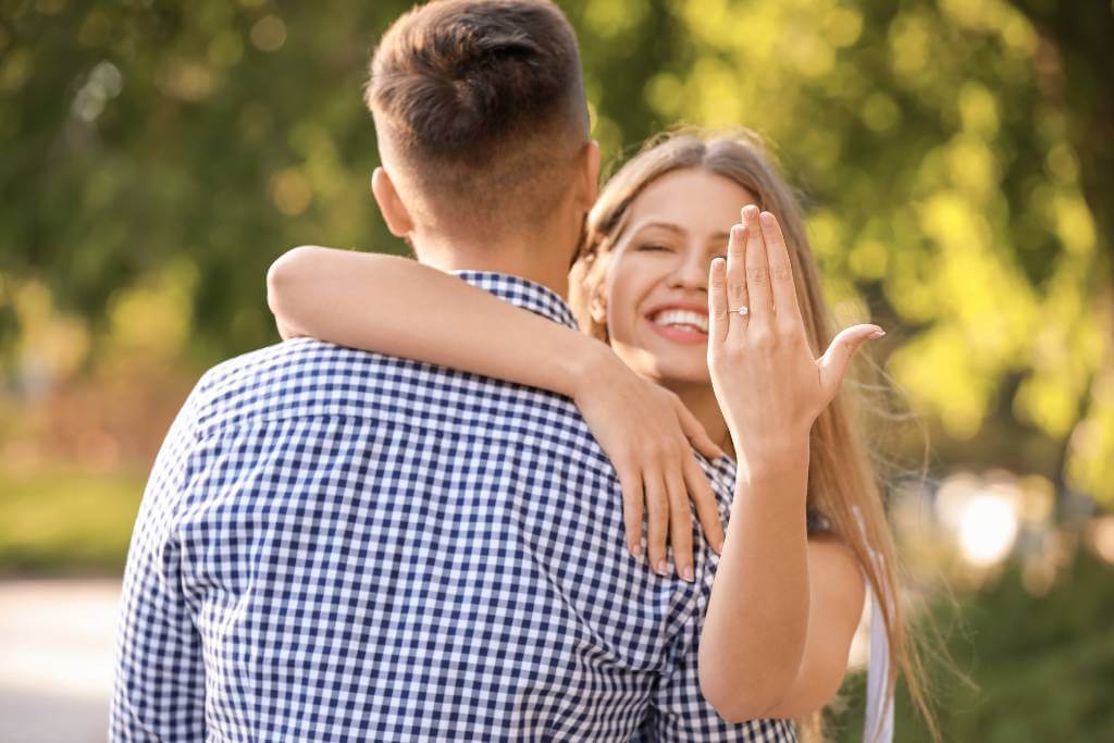 engaged couple park proposal moment