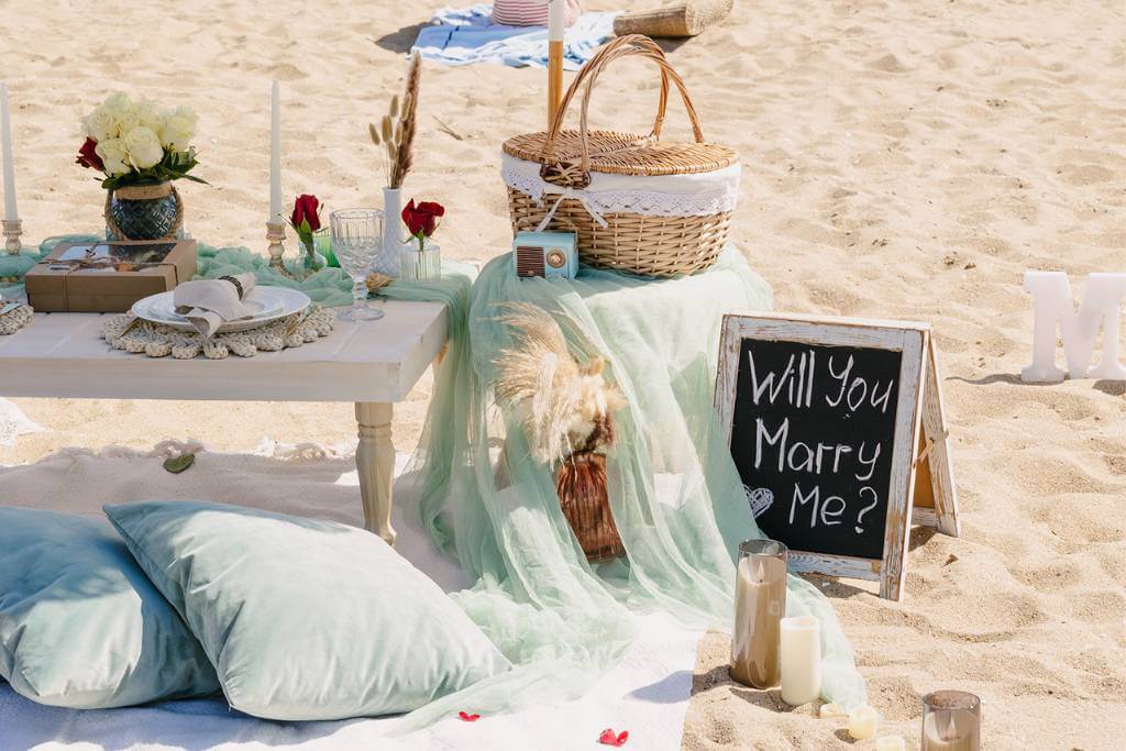 romantic beach picnic proposal setup