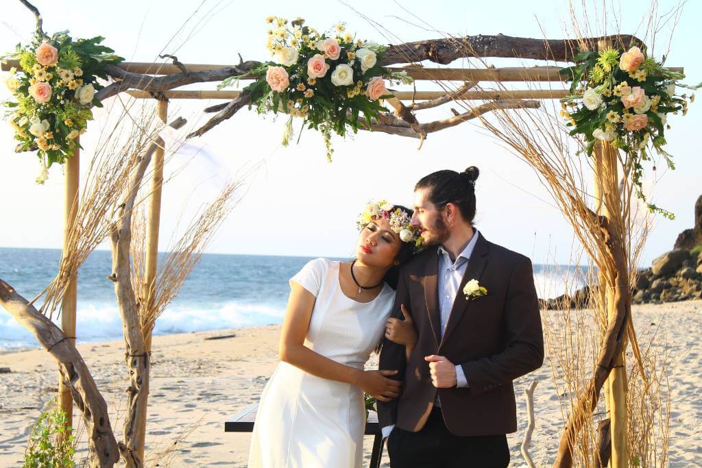 seaside wedding under floral arch
