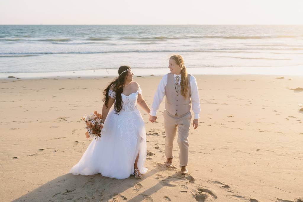 couple walking beach wedding