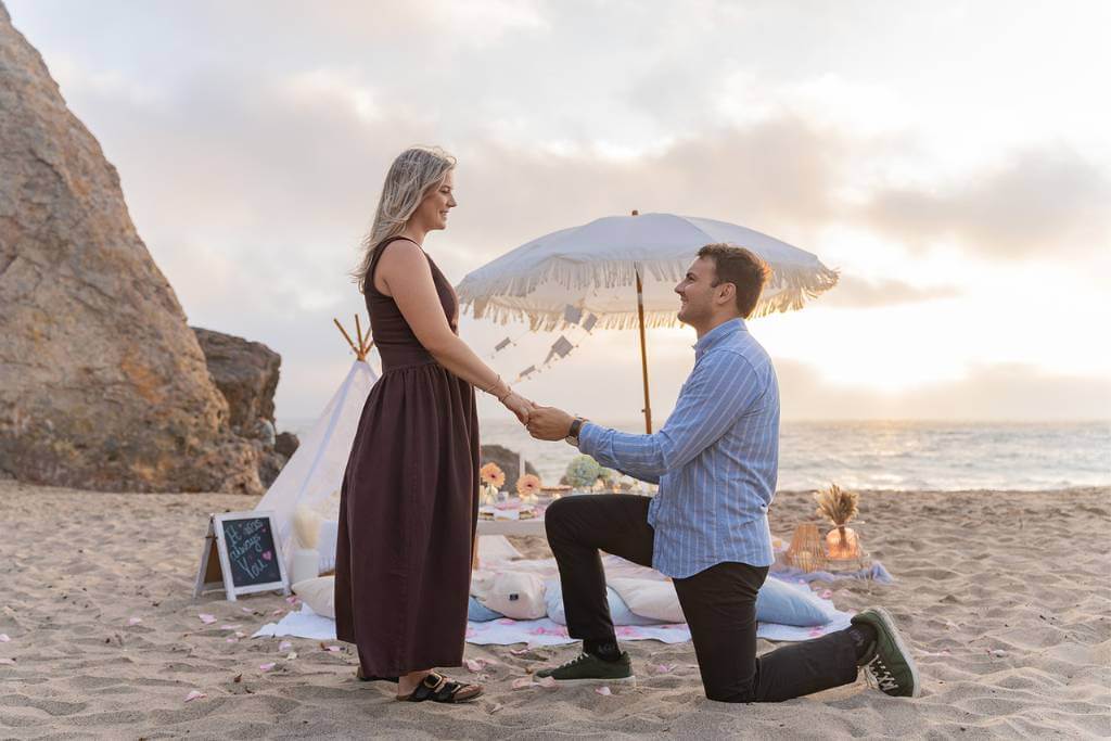 teepee beach proposal on one knee