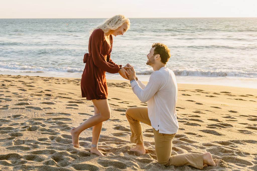 beach proposal on one knee