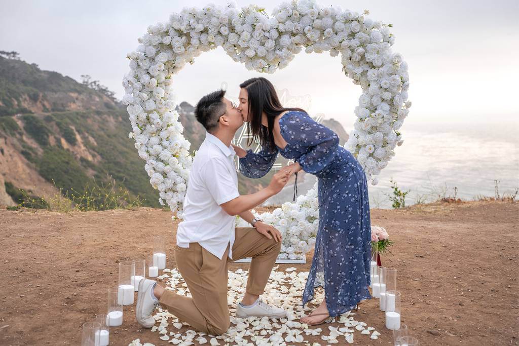 cliffside proposal under floral arch