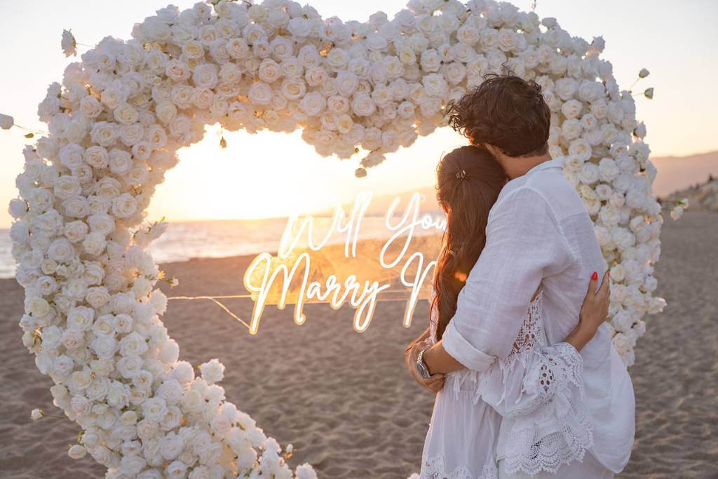 woman proposing to man at sunset