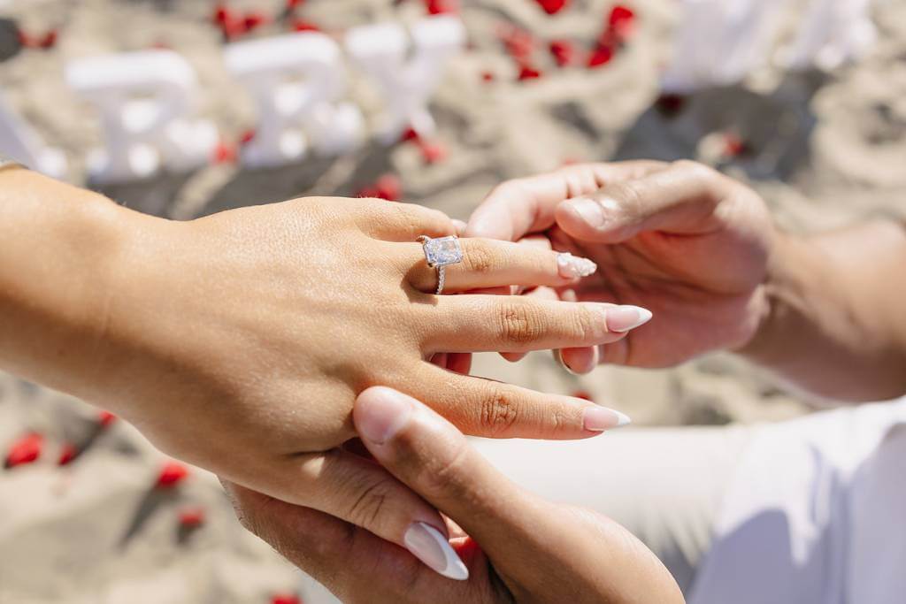 engagement season ring placement on beach