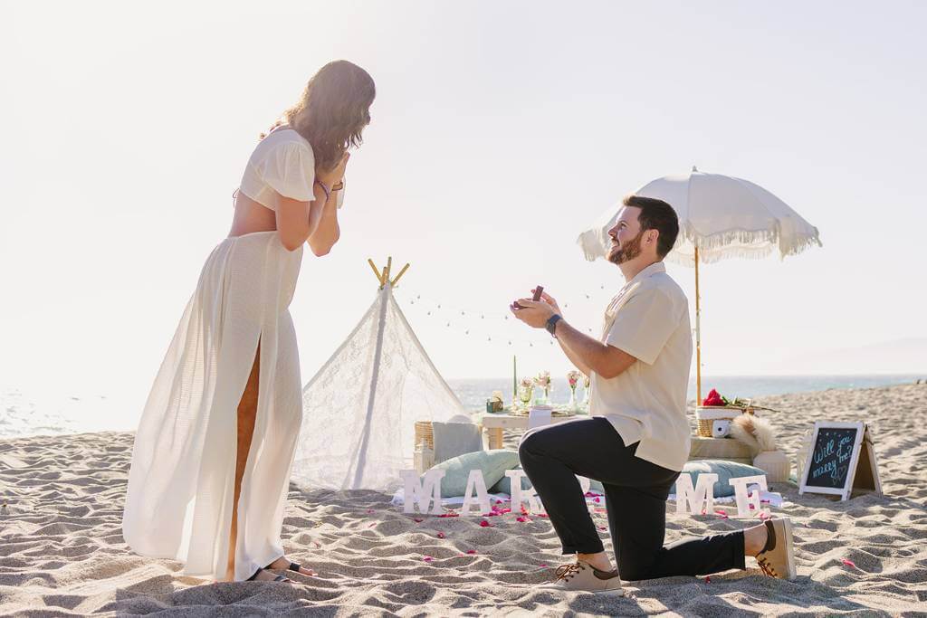 intimate beach proposal teepee setup