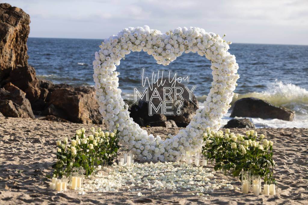 private beach proposal heart arch