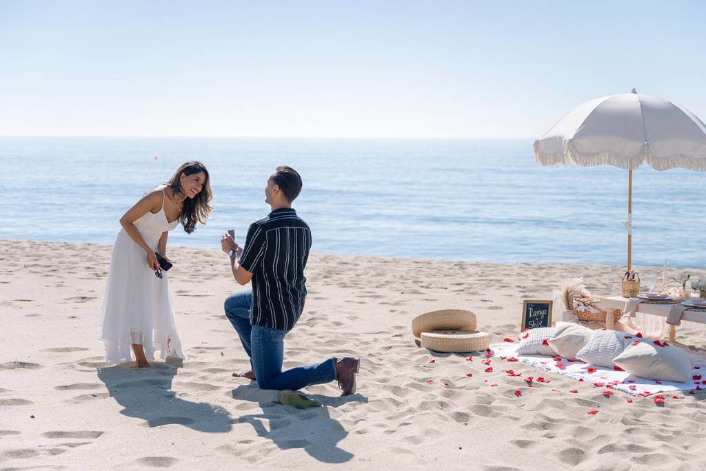 private beach proposal on one knee