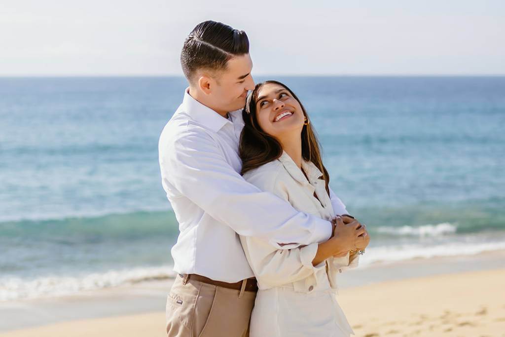 close embrace beach engagement pose