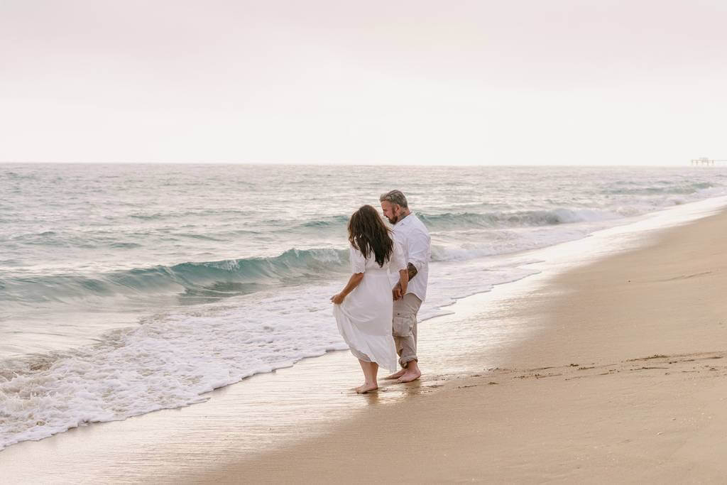 candid shoreline walk engagement pose